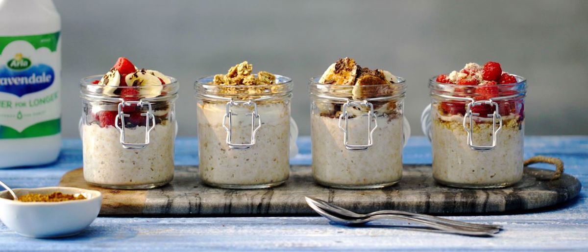 4 mason jars of overnight oats with various fruit toppings