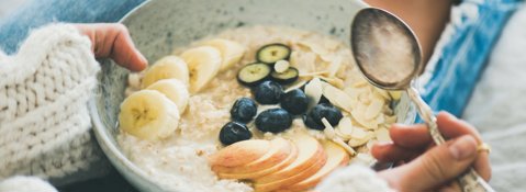 A bowl of porridge topped with fruit