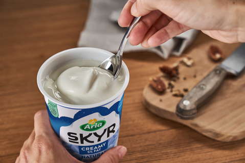 Silver spoon scooping up a spoonful of Arla Skyr