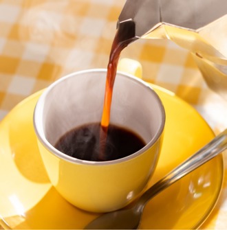 Black coffee being poured into a cup