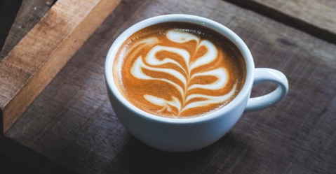 A cup of coffee with wavy latte art