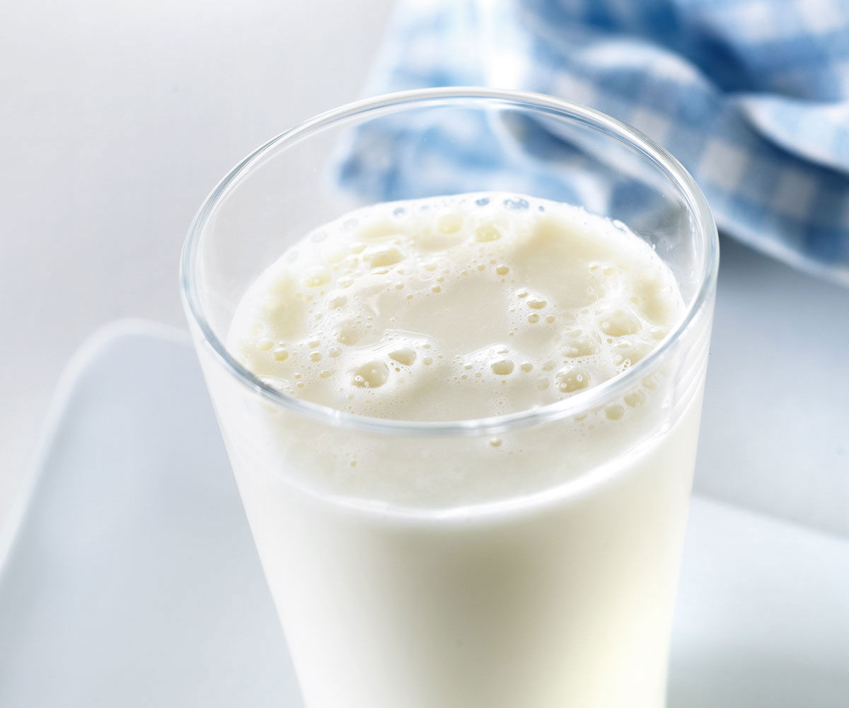A close up on a glass of freshly poured milk