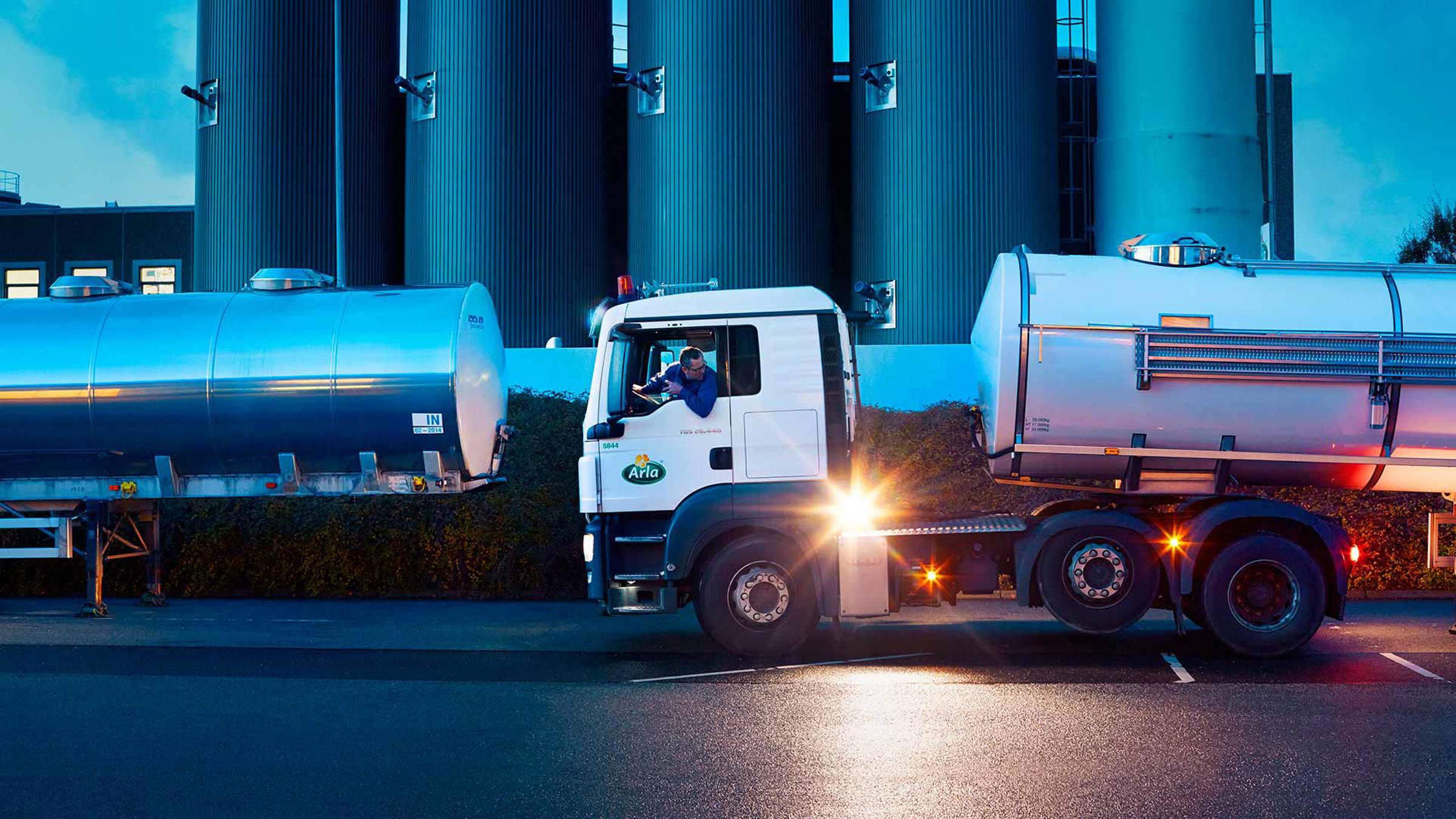 Arla tanker truck backing up onto a parking space at a factory