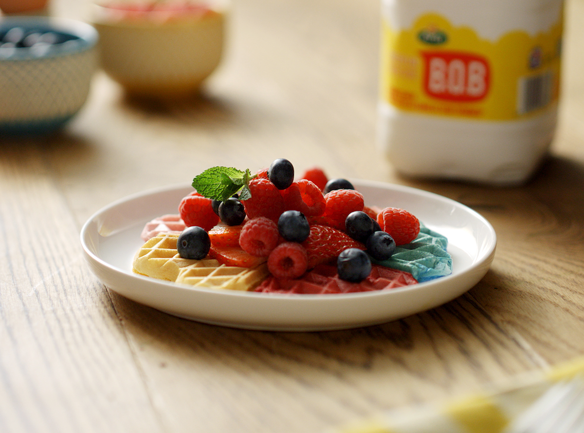 Rainbow waffles topped with berries and mint