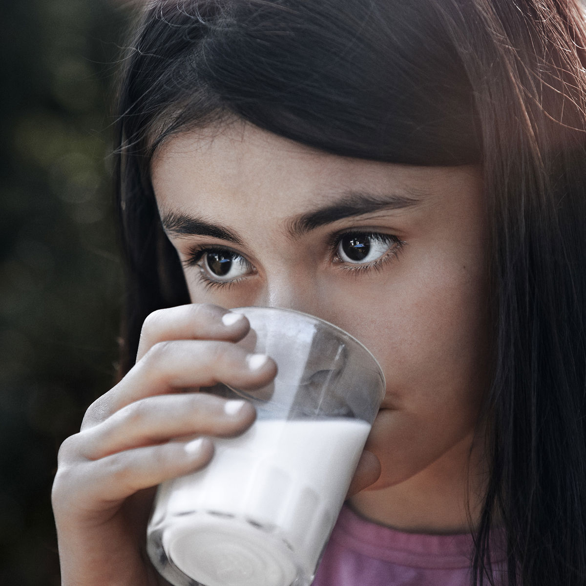 A girl drinking a glass of milk