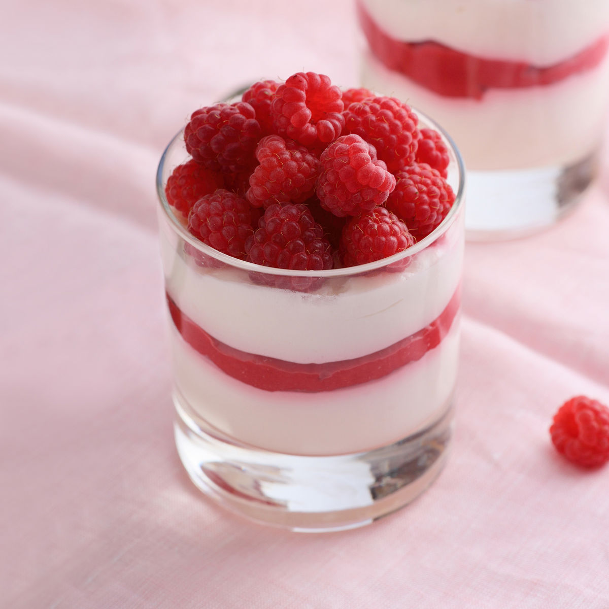 A glass of raspberries and yogurt