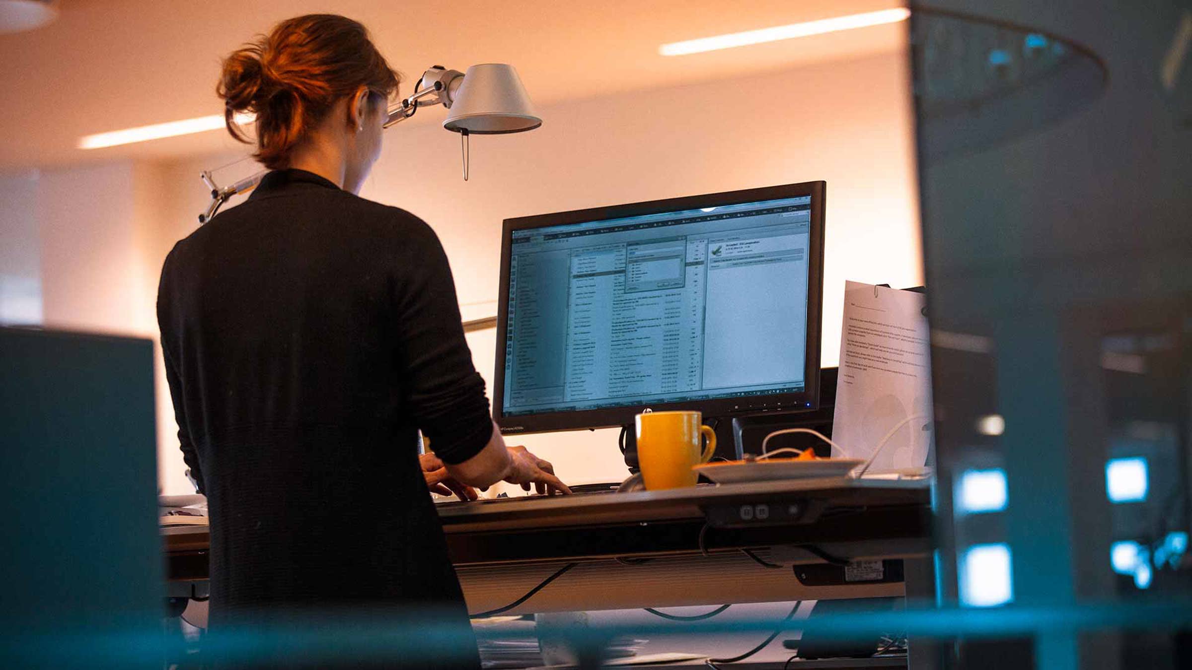 An office worker typing at her desk