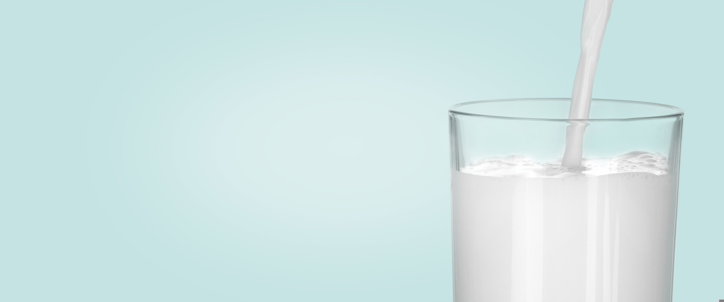 Milk being poured into a tumbler