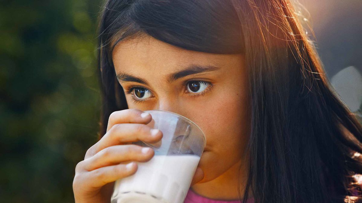 Girl drinking a glass of milk