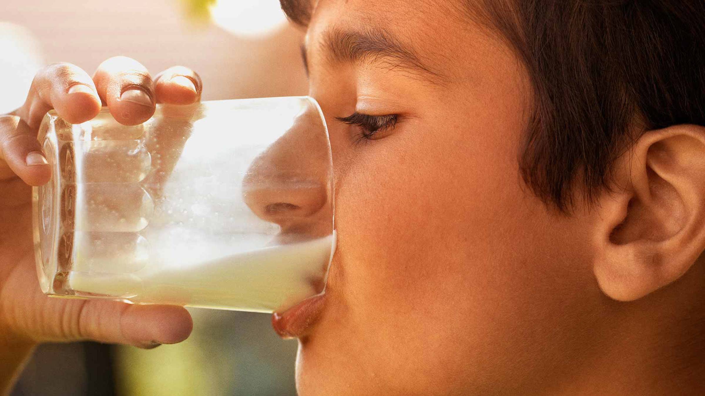 A child drinking a glass of milk