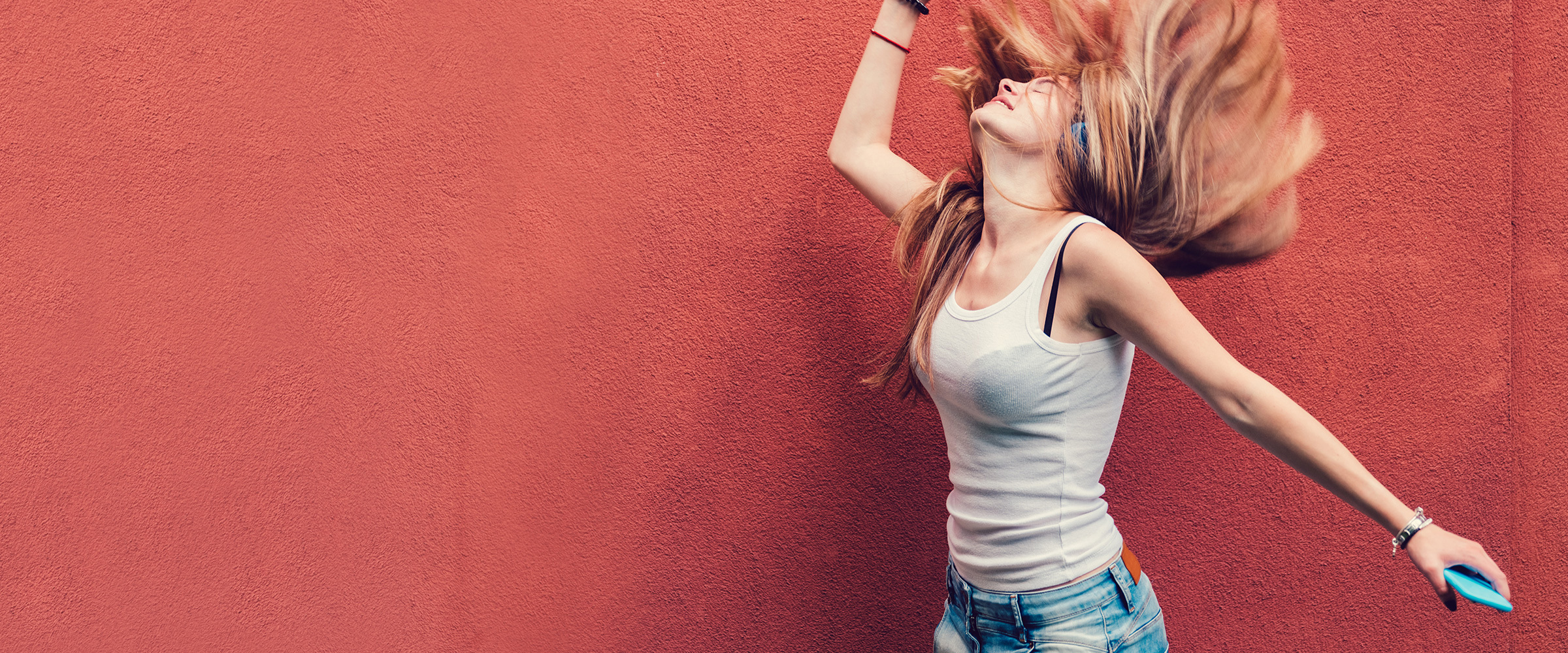 Woman throwing back her hair listening to music