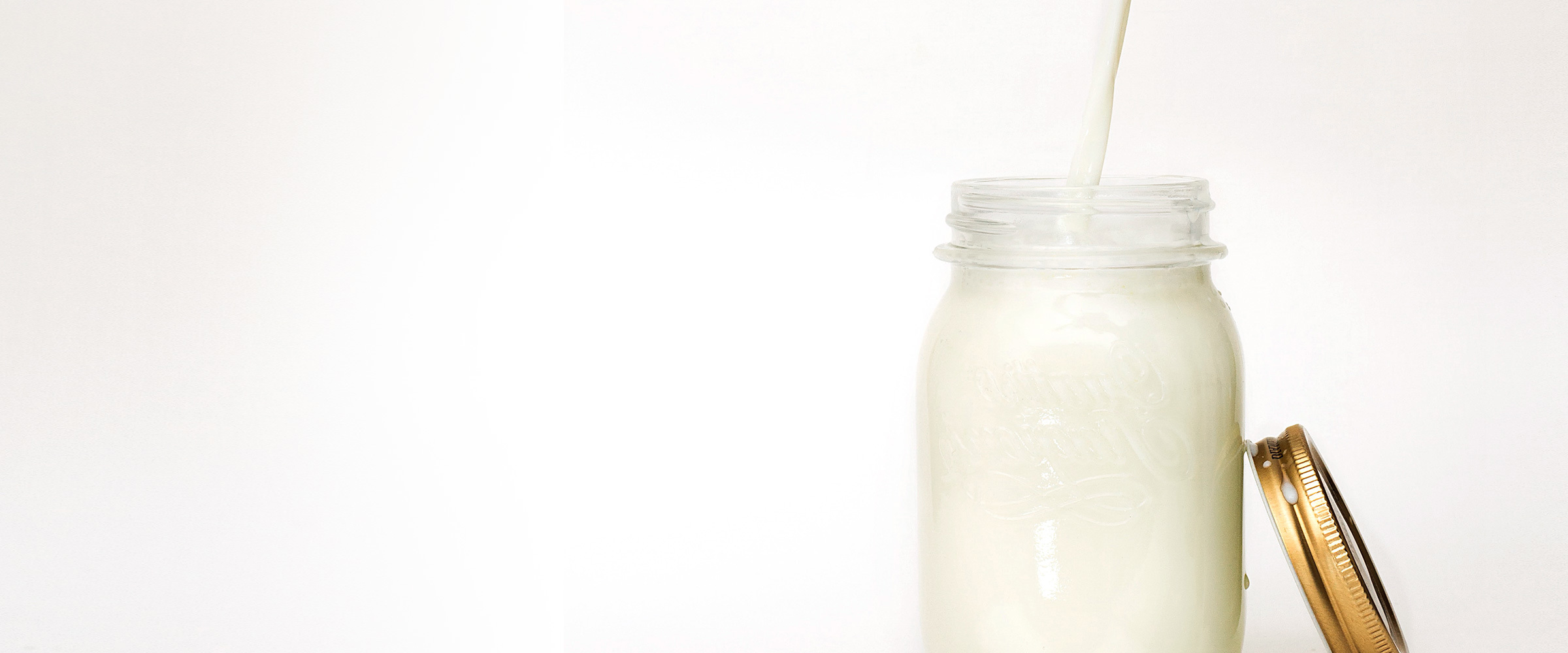 Milk being poured into a jar