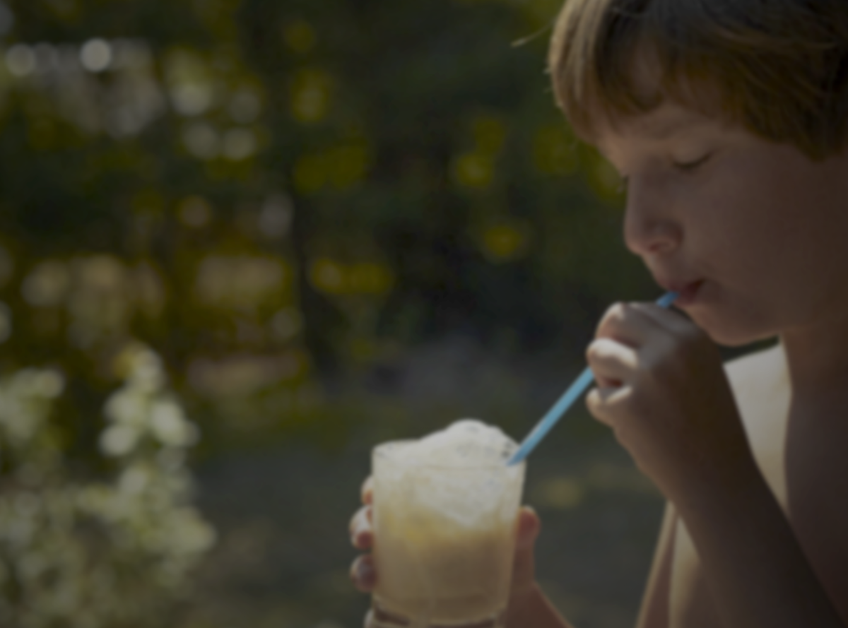 Child drinking a milk drink outside