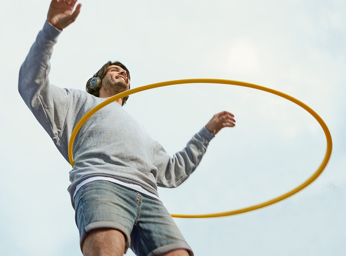 Man hula hooping with headphones on