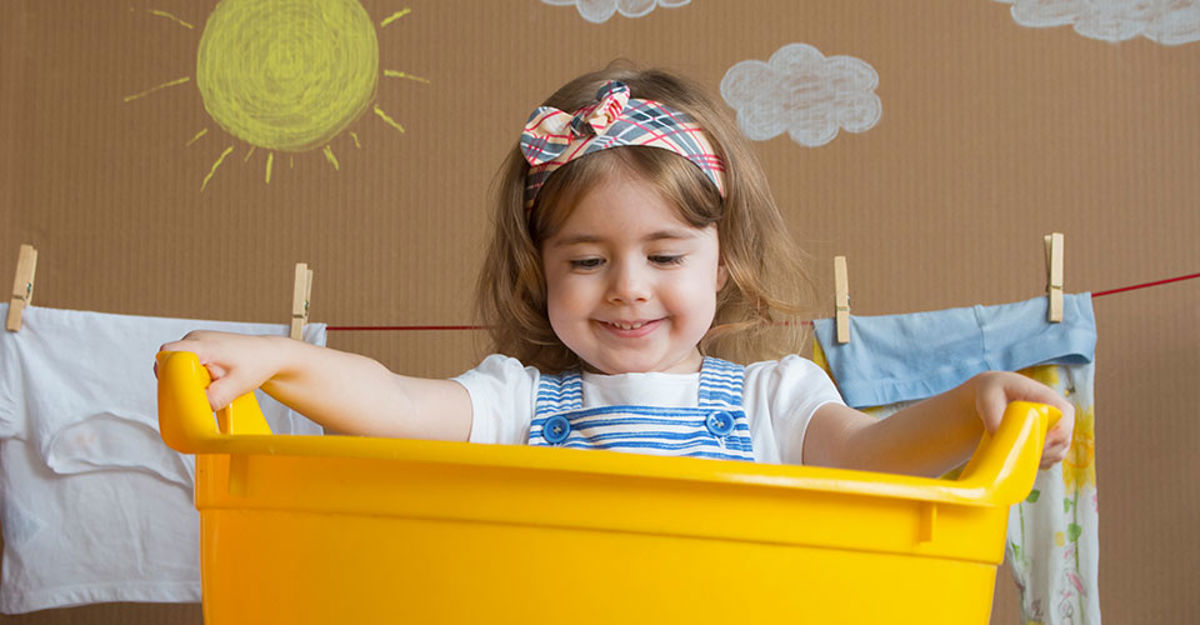 A child playing in a plastic tub