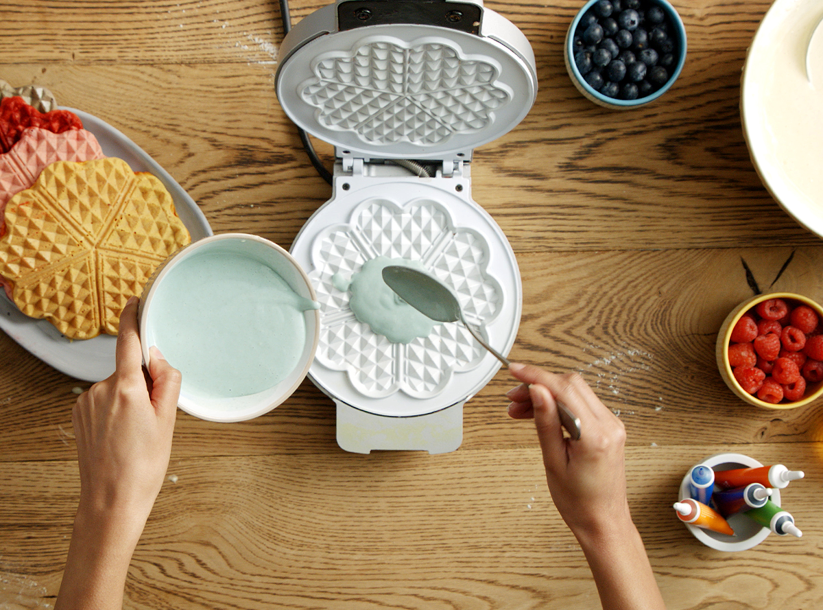 Waffle batter being poured onto a waffle iron