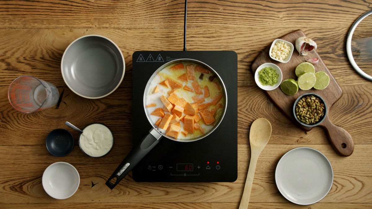 Milk, pumpkin, onions, butter and stock cubes cooking in a pot