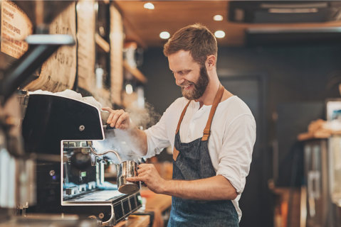 Barista making coffee at a coffee machine