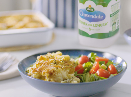 Creamy 'Waste Less’ Mac and Cauliflower Cheese next to a bottle of Cravendale
