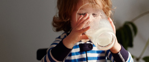 Child drinking a glass of milk
