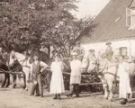 An old black and white photo of farmers on horses