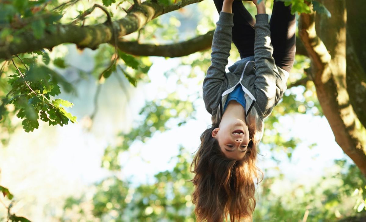 Girl hanging from a tree