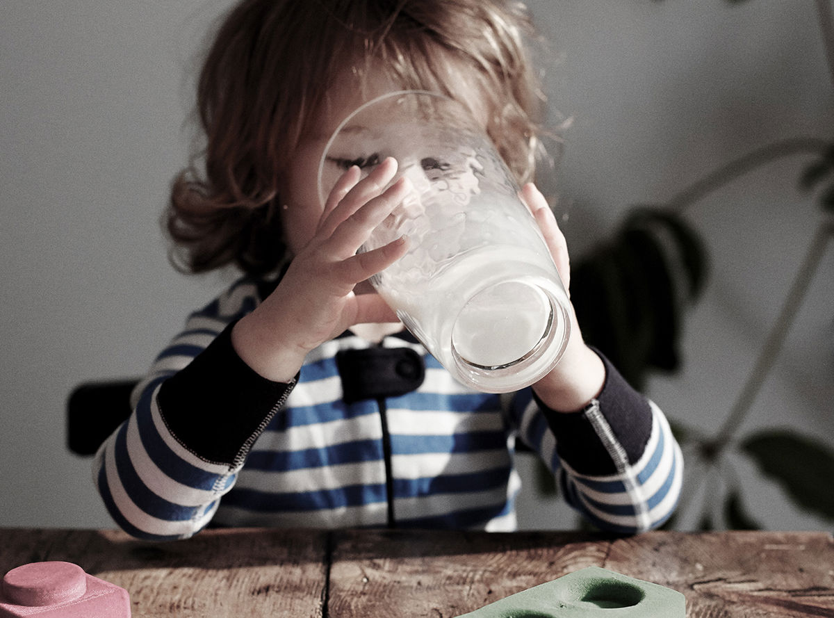 A child drinking a glass of milk