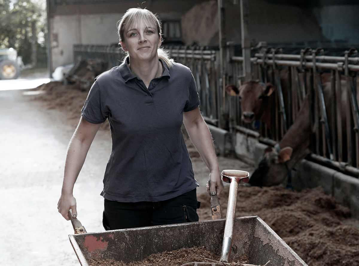 A farmer wheeling a wheelbarrow