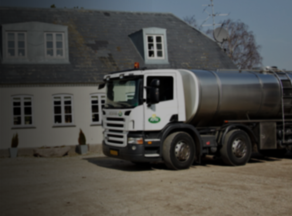 An Arla tanker in front of a rural building