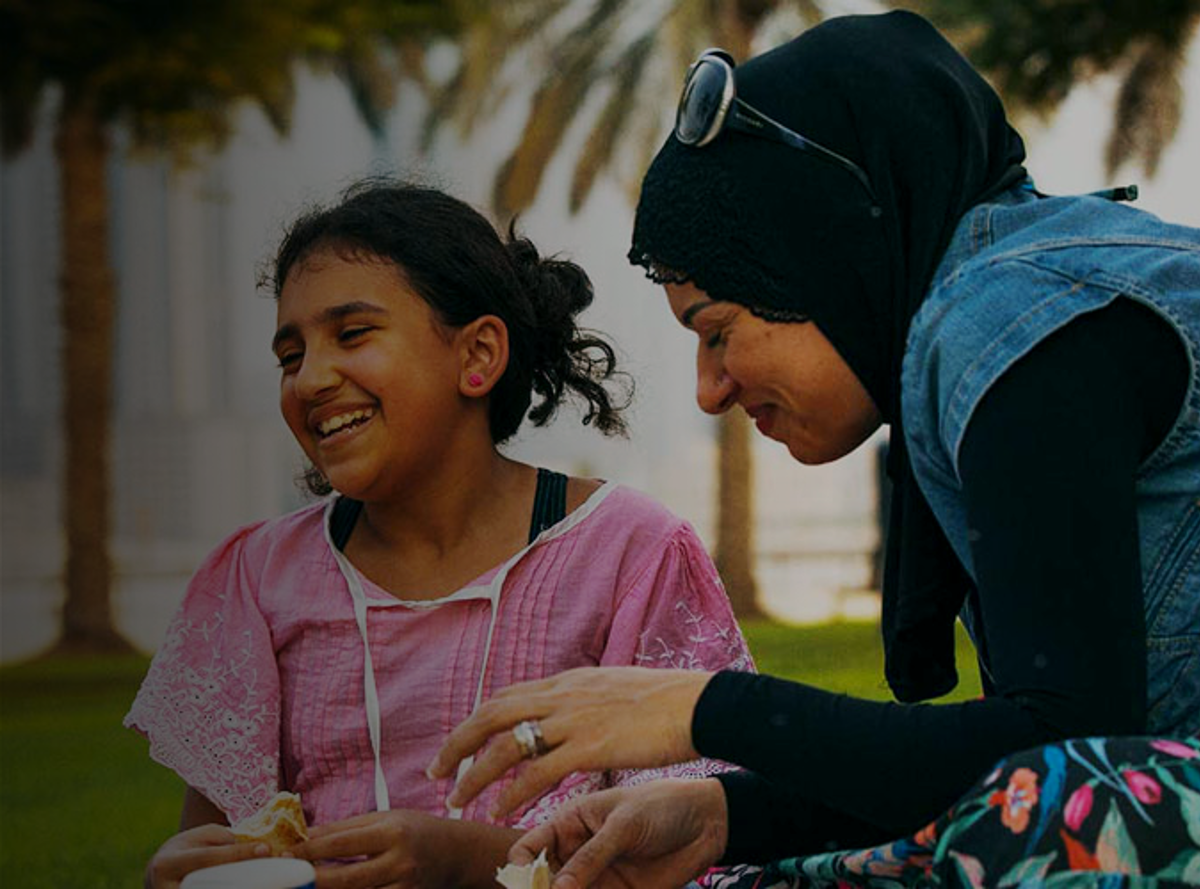 A mother and child laughing during a picnic